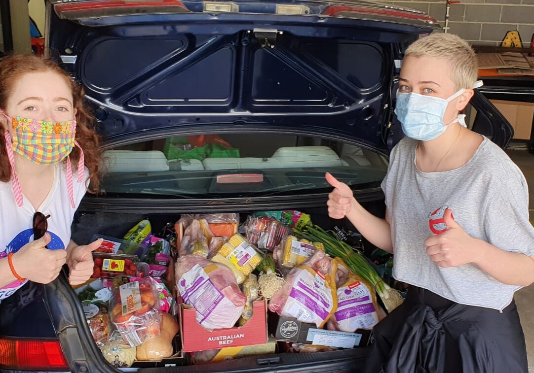 Volunteers with a boot full of ingredients